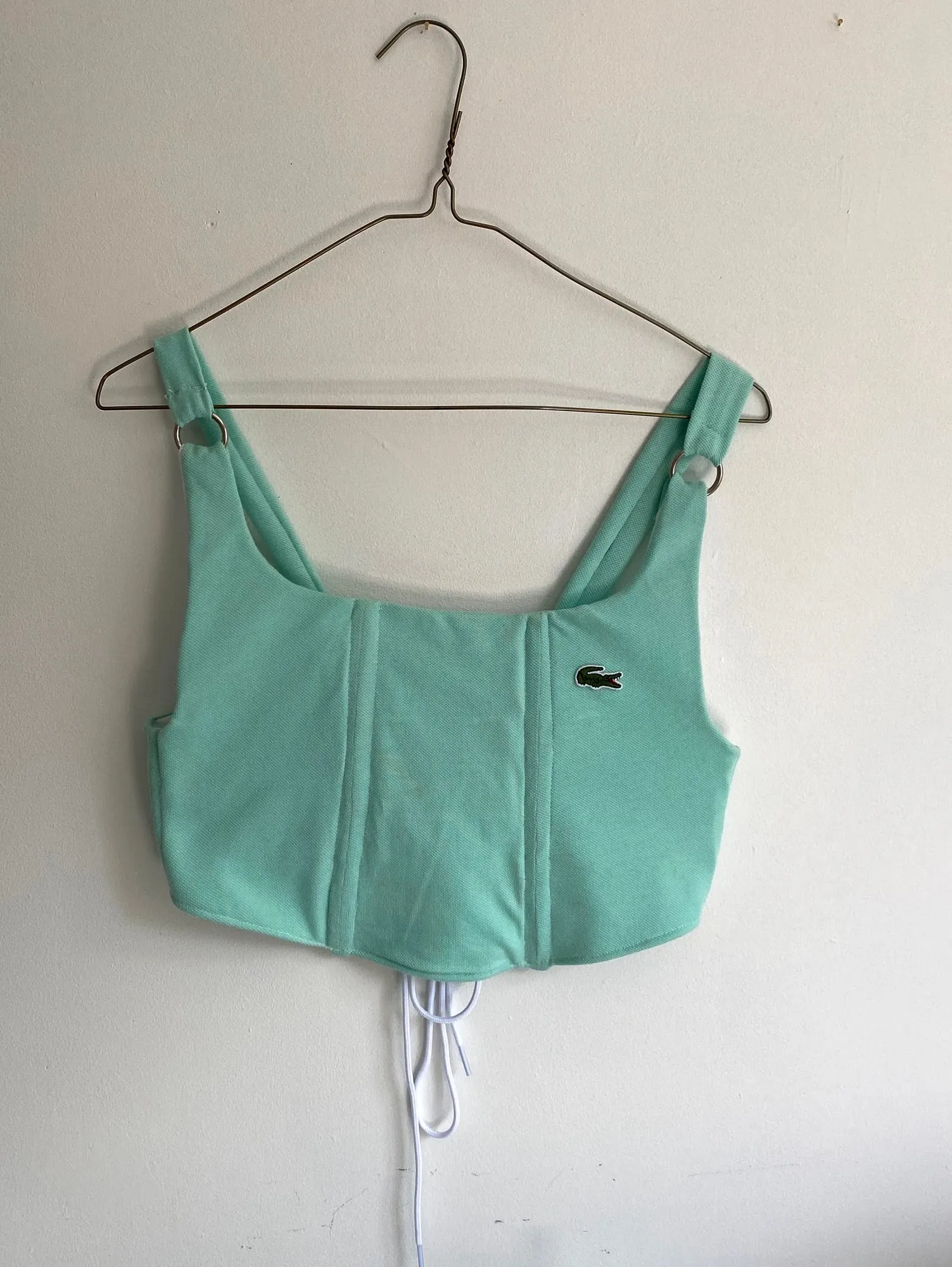 The finished corset top on a hanger