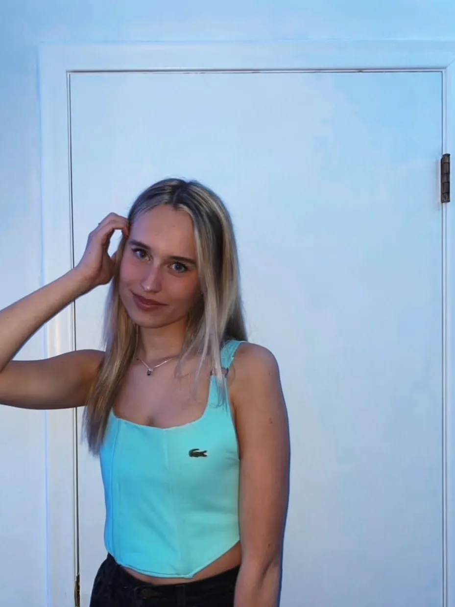 Eryn wearing the mint corset top with dark jeans